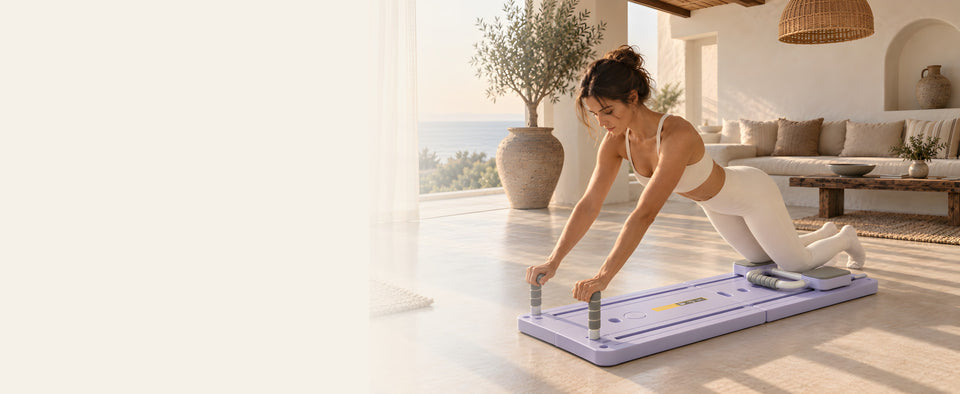 Woman holding a plank on the lilac foldable reformer board in a bright living room facing the sea